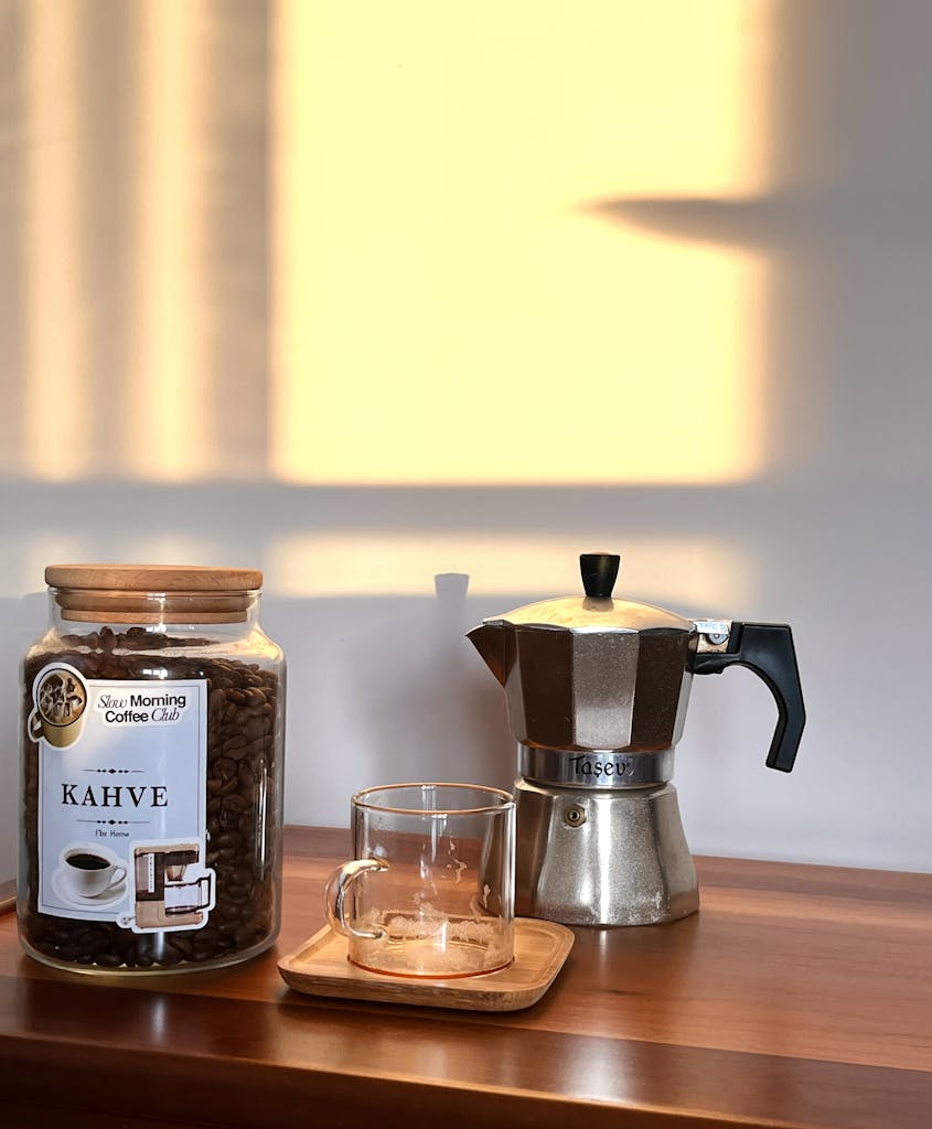 A cozy coffee corner with an espresso maker and coffee beans basking in morning light.